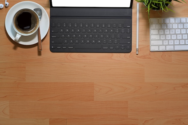 Workplace office  wooden desk with blank screen tablet and copy space