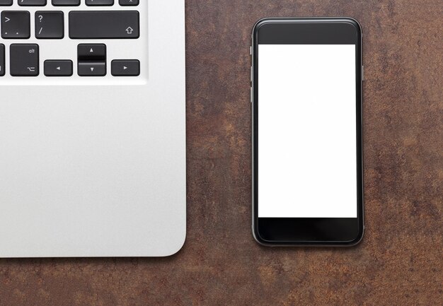 Workplace phone and a laptop on the table