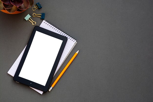 Workplace. Phone, tablet and notepad on the table. 