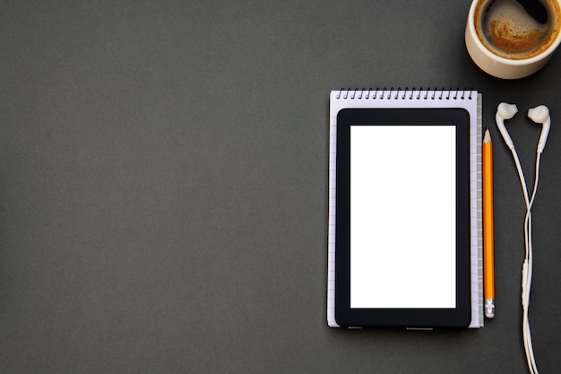 Workplace. Phone, tablet and notepad on the table. 