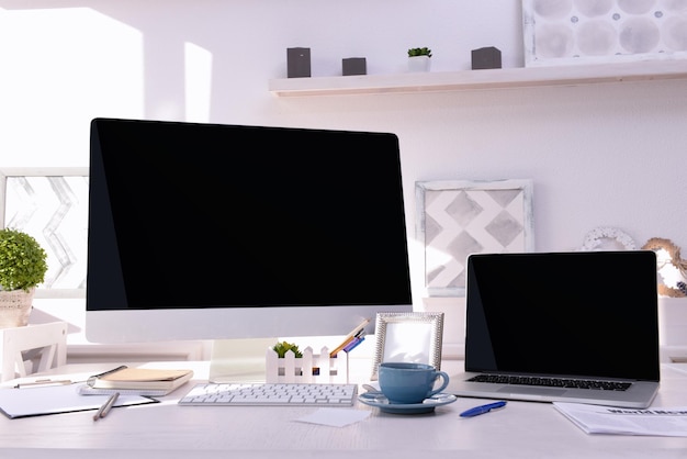 Workplace with computer and laptop on the table