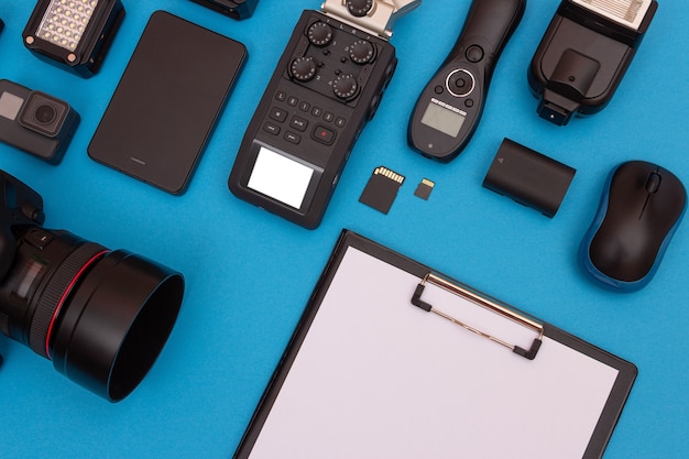 Photo workplace with digital gadgets on blue table