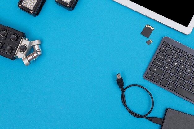 Workplace with digital gadgets on blue table