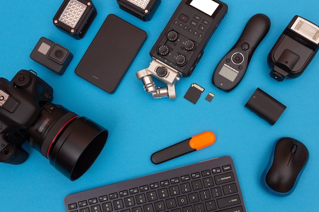 Photo workplace with digital gadgets on blue table