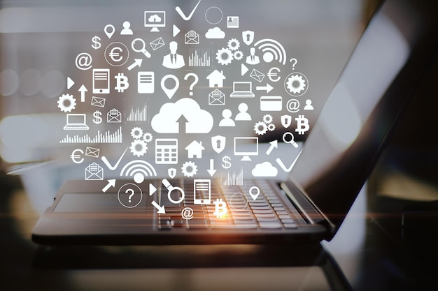 Workplace with laptop on table and cloud computing diagram