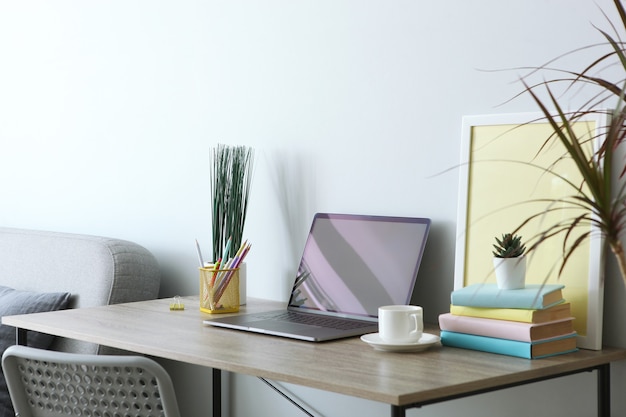 Workplace with modern laptop in the interior of the room