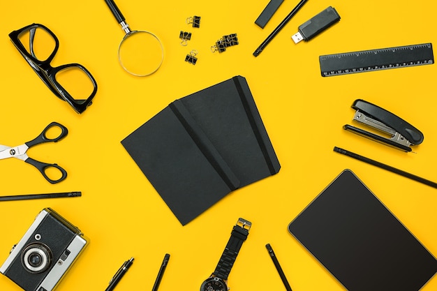 Workplace with office items and business elements on a yellow background. concept for branding. top view. copy space. still life