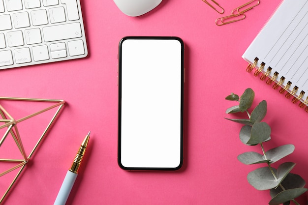 Photo workplace with phone with empty screen, top view