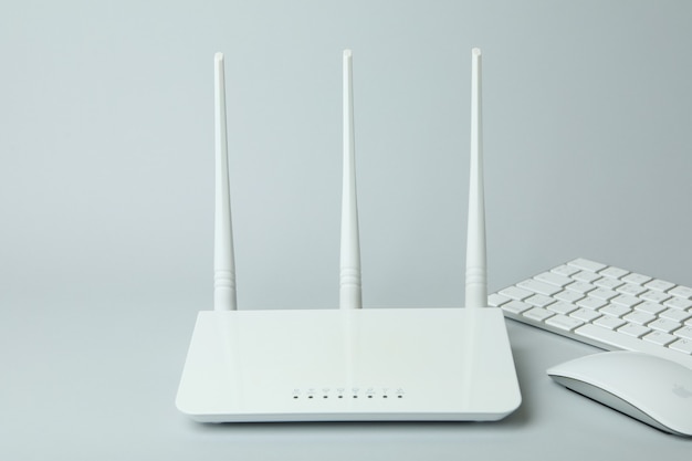 Workplace with Wi - fi router on gray background