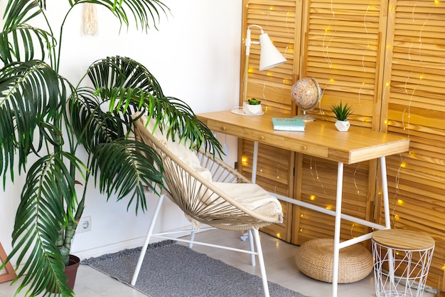 Workplace with wooden desk and plants