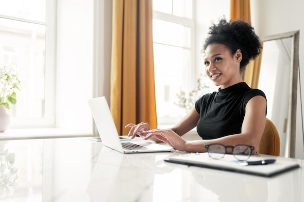 Works in the office uses a laptop prints a letter to the post\
office female freelancer online