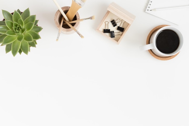 Workspace accessories coffee and a succulent plant on a white table Flat lay with blank copy space