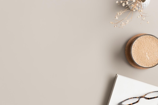 Photo workspace accessories and a cup of coffee on a beige table flat lay with blank copy space