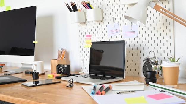 Workspace computer with graphic designer table in real studio.