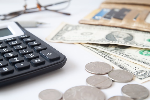 Workspace desk with money, purse and calculator. Business and Financial concept