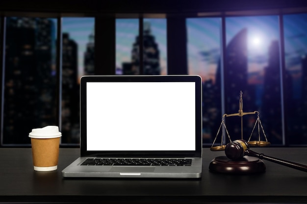 Workspace of lawyer with laptop blank white screen and law gavel and brass scale of judge courtroom legal conceptxA