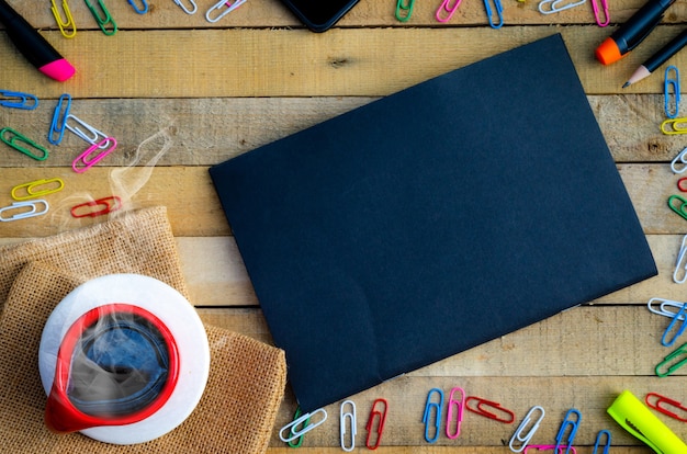 workspace mockup on a wooden table, cup of coffee and supplies