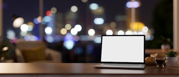 Workspace at night a laptop mockup on a desk in a contemporary private office room on a skyscraper