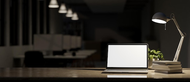 Workspace at night with laptop mockup light from table lamp and copy space on tabletop