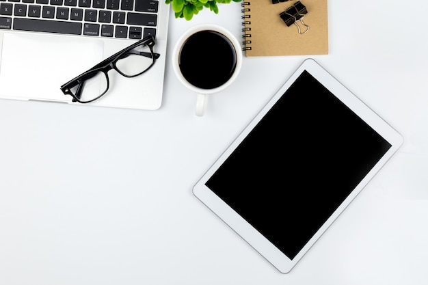 Workspace in office with tablet and with empty blank screens.