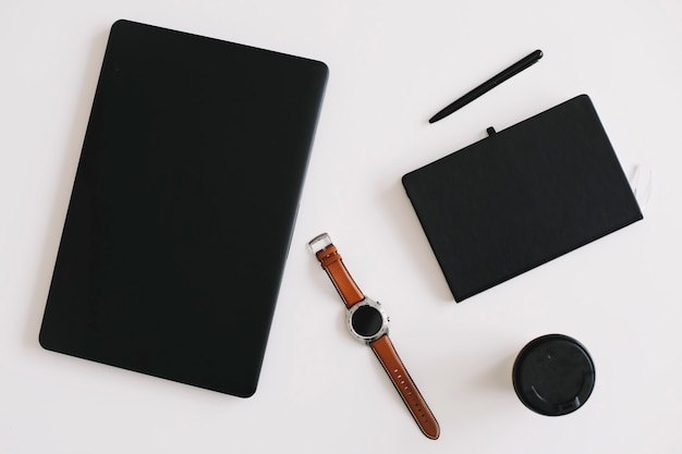 workspace surface with laptop coffee pen and notebook flat lay top view