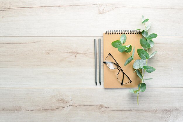 Workspace with blank note book Flat lay top view office table desk