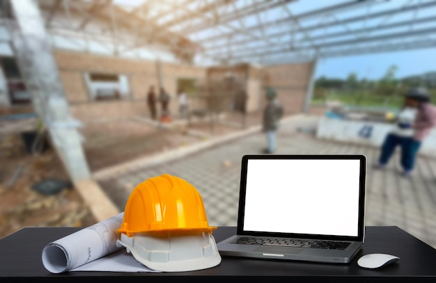 Workspace with desktop computer concept architects or engineer\
at construction site at desk in office