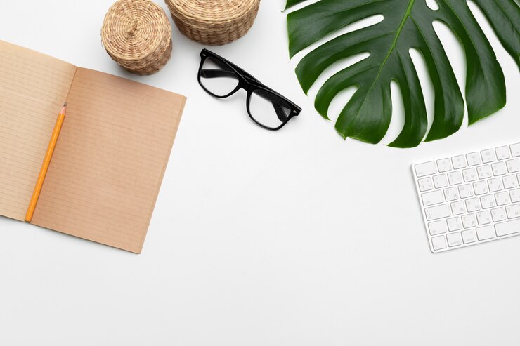 Photo workspace with keyboard, palm leaf and accessories. flat lay, top view copy space