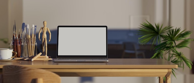 Workspace with laptop computer mockup painting tools supplies and copy space on wooden desk