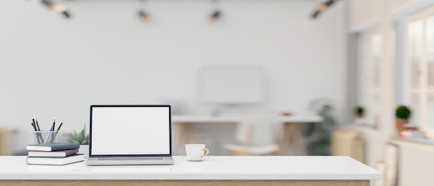 Workspace with laptop mockup and copy space on a white tabletop in a modern office