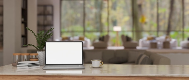 Workspace with laptop mockup on a table over blurred background of a modern lounge with sofa