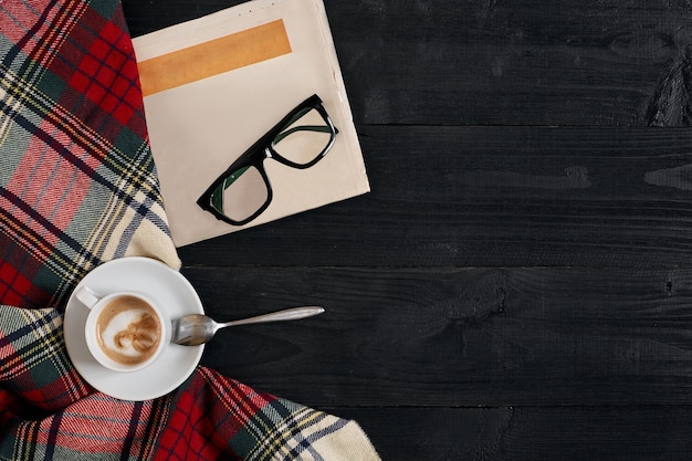 Workspace with newspaper coffee cup scarf glasses stylish office desk autumn or winter concept flat ...