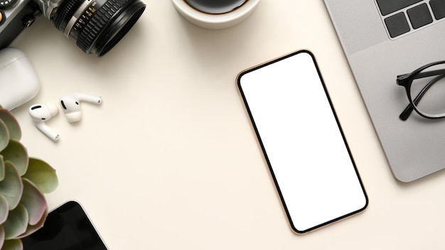 Workspace with office accessories and mobile phone white screen mockup on white background top view