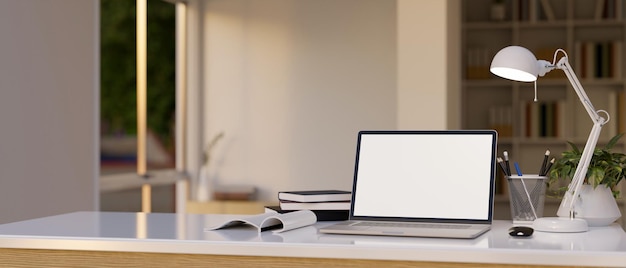 Workspace with white screen laptop mockup on a white tabletop in a modern room