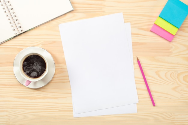 Workspace on wooden table with blank sheet of paper. Desktop mix on a wooden office table. Flat lay