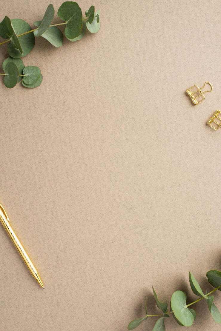 Photo workstation concept top view vertical photo of eucalyptus branches gold pen and binder clips on beige background with copyspace