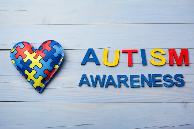 Photo world autism awareness day with puzzle or jigsaw pattern on heart