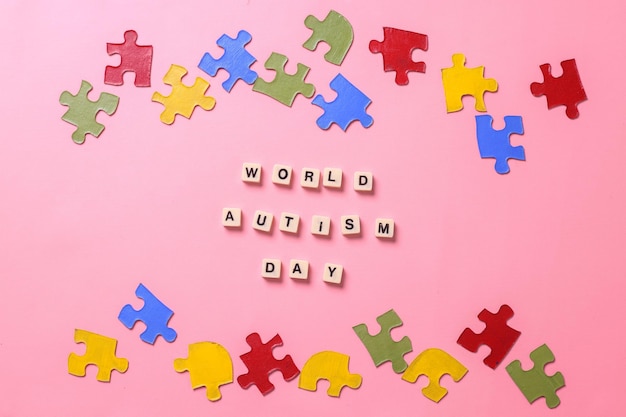 World Autism Day lettering arranged with colorful puzzle pieces. World Autism Awareness Day.