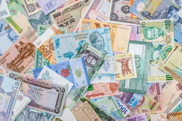 World banknotes collection mixed on table, top view