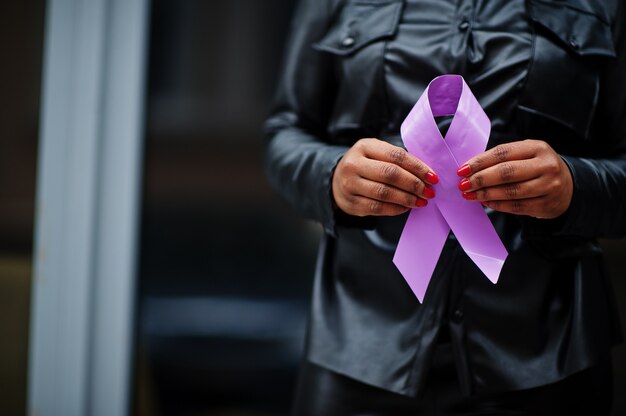 Photo world cancer day concept, february 4. african american woman hold purple ribbon awareness.