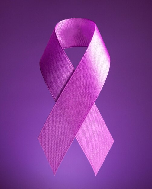 World cancer day purple ribbon on a purple background anticancer tape