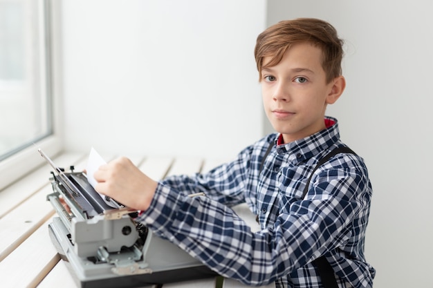 World day of the writer concept - Boy with an old typewriter