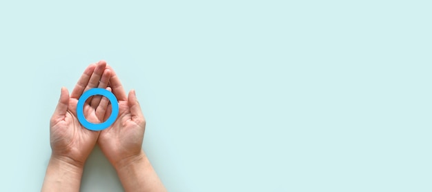 World diabetes day inscription Blue circle in woman hands on a blue background 14 november