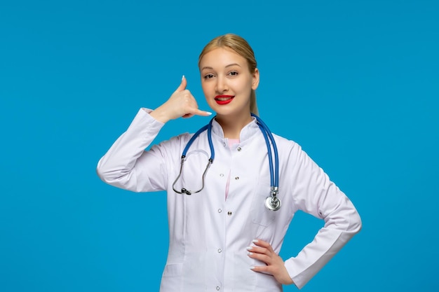 World doctors day smiling doctor showing calling sign with the stethoscope in the lab coat