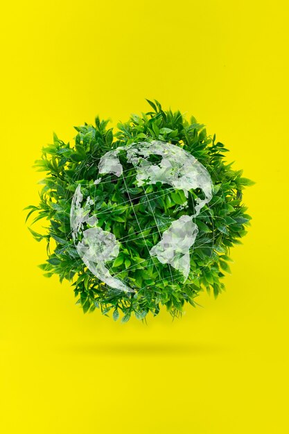 Foto giornata mondiale per l'ambiente. concetto ecologico: un globo d'erba su sfondo giallo.