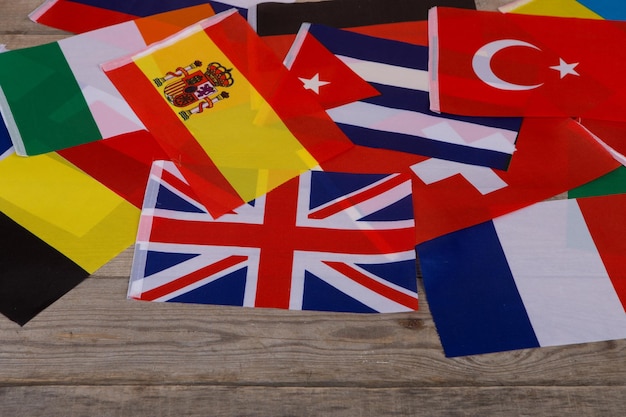 World flags little flags of different countries on wooden table