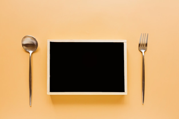 World Food Day concept with black chalkboard and cutlery 