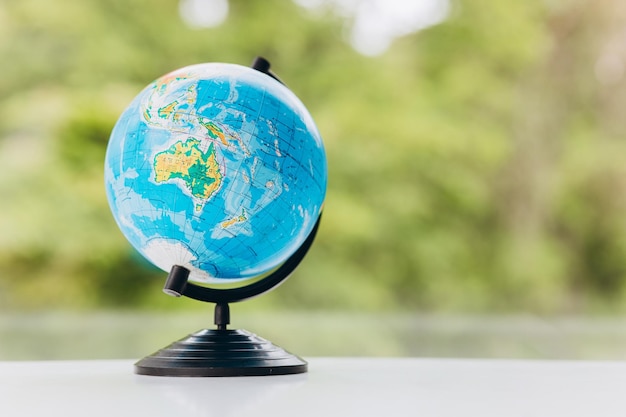 World globe on desk over green background