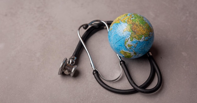 World Health Day Global Health Awareness Concept Handmade Globe inside Stethoscope as Heart