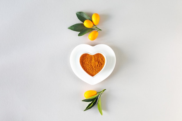 World Health Day. Turmeric in a heart shaped plate. Healthy food concept, top view.